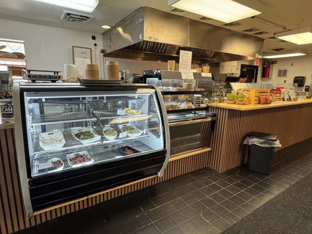 The scratch-made deli case at CC's Market, stocked with prepared salads and meats